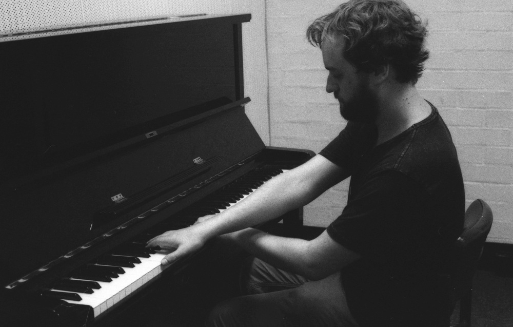 A photo of Matthew Prain playing the piano